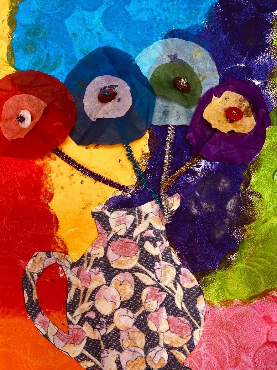 Tissue paper flowers with buttons in a patterned jug
