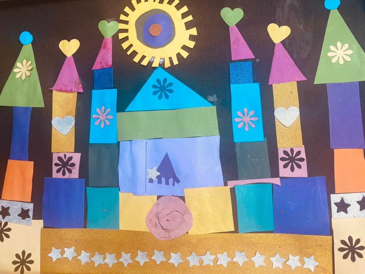 A paper collage castle with hearts and stars