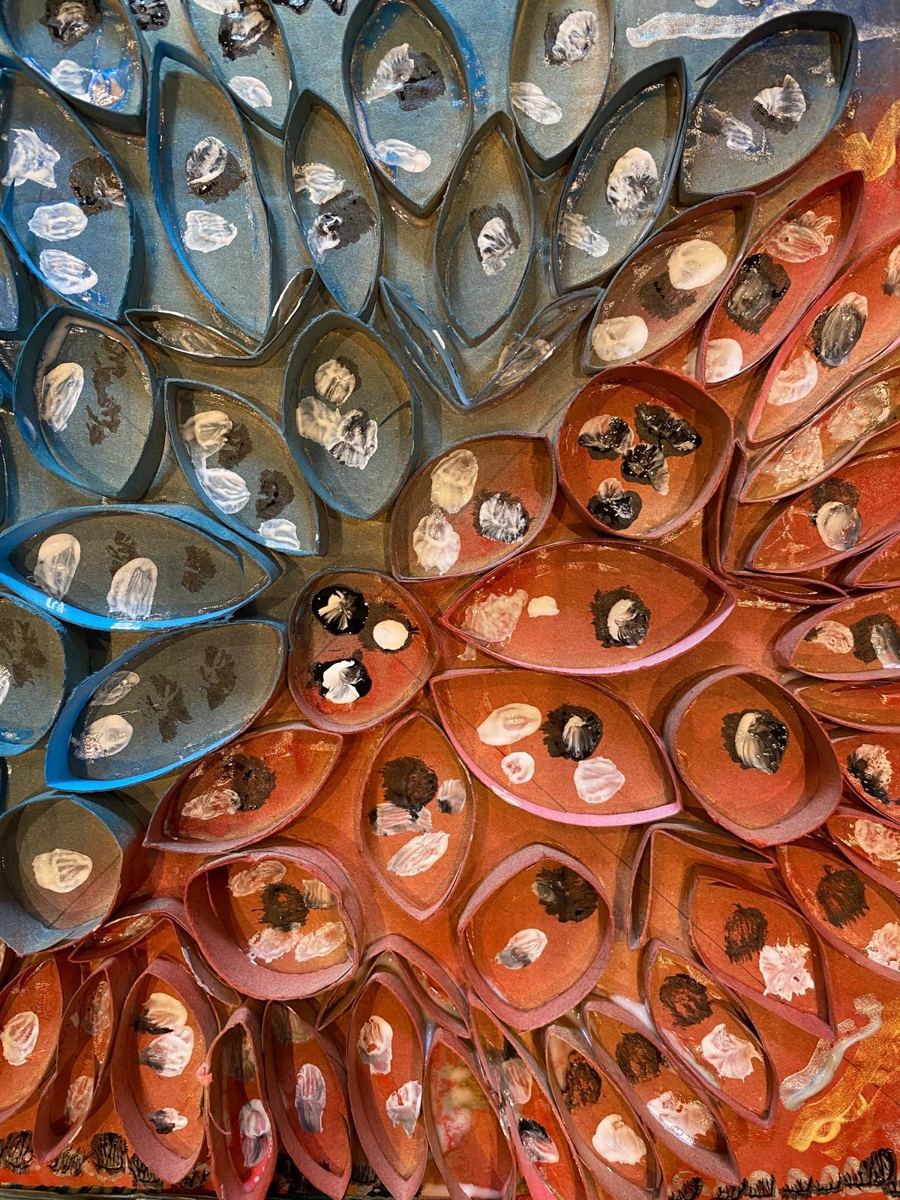 A flower sculpture made from painted cardboard tubes